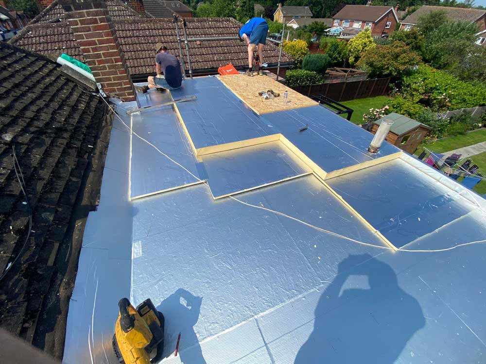 Avalon Roofing | Flat Roofs| Image showing flat roof insulation being fitted